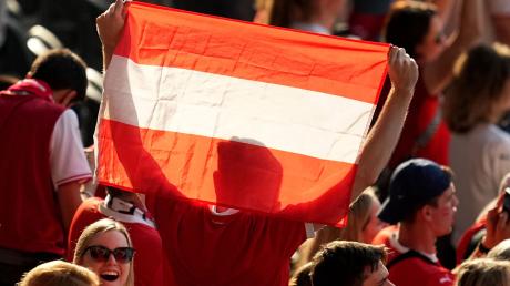 Ein Fan hält nach dem Sieg eine österreichische Fahne in die Höhe.